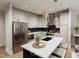 A well-lit, modern kitchen featuring stainless steel appliances, marble countertops, and pendant lighting over the island at 3926 Lost Fawn Ct, Raleigh, NC 27612