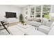 Bright living room with large windows, neutral decor, comfortable seating, and stylish accents, creating a welcoming space at 3926 Lost Fawn Ct, Raleigh, NC 27612
