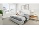Bright main bedroom features large windows, neutral tones, and stylish bedside tables at 3926 Lost Fawn Ct, Raleigh, NC 27612