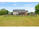 Fenced backyard with well-manicured lawn, stone fireplace, patio and covered deck at 40 Senter Farm Ct, Fuquay Varina, NC 27526