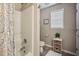 A practical bathroom featuring a shower-tub combo and a window for natural light at 40 Senter Farm Ct, Fuquay Varina, NC 27526