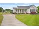 View of home with a long driveway, carport, and beautiful landscaping at 40 Senter Farm Ct, Fuquay Varina, NC 27526