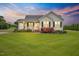 Charming one-story home featuring a covered front porch, black shutters, and a well-manicured lawn at 40 Senter Farm Ct, Fuquay Varina, NC 27526