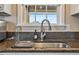 Close up of kitchen sink and faucet, featuring dark countertops and a window at 40 Senter Farm Ct, Fuquay Varina, NC 27526