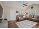 Cozy living room with vaulted ceilings, ceiling fan, hardwood floors, and comfortable couches at 40 Senter Farm Ct, Fuquay Varina, NC 27526