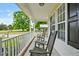 Relaxing porch view with rocking chairs, white railings, and large windows at 40 Senter Farm Ct, Fuquay Varina, NC 27526