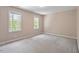 Spacious bedroom featuring neutral walls, carpet, and dual windows providing ample natural light at 4012 Graham Newton Rd, Raleigh, NC 27606