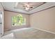 Bedroom featuring a large window allowing ample natural light and neutral carpeting at 4012 Graham Newton Rd, Raleigh, NC 27606