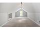 Finished bonus room featuring sloped ceiling, carpet, and a bright window with green outdoor views at 4012 Graham Newton Rd, Raleigh, NC 27606