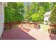Inviting wood deck overlooking a lush backyard with mature trees and a storage building at 4012 Graham Newton Rd, Raleigh, NC 27606