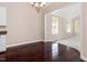 Dark wood floors in dining room. Transition to another room with light colored carpet at 4012 Graham Newton Rd, Raleigh, NC 27606