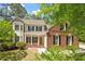 Charming two-story home with a brick and siding exterior, complemented by a well-manicured front yard at 4012 Graham Newton Rd, Raleigh, NC 27606