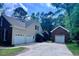 View of the three car garage and detached garage with an extra wide concrete driveway at 4012 Graham Newton Rd, Raleigh, NC 27606