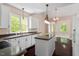 A view from the kitchen into another room showing white cabinets and island at 4012 Graham Newton Rd, Raleigh, NC 27606