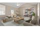 Bright living room with vaulted ceiling, neutral color palette, and view to kitchen at 4012 Graham Newton Rd, Raleigh, NC 27606