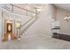 Open-concept living area with staircase and views of kitchen and entry at 4012 Graham Newton Rd, Raleigh, NC 27606
