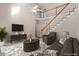 Cozy living room with a staircase, ceiling fan, and comfortable seating at 4012 Graham Newton Rd, Raleigh, NC 27606