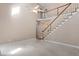 Bright, open living room features a staircase, ceiling fan, and light-colored carpet at 4012 Graham Newton Rd, Raleigh, NC 27606