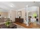 Staged living room featuring hardwood floors, tan walls, staircase, and decorative furniture at 4012 Graham Newton Rd, Raleigh, NC 27606