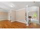Spacious living room with hardwood flooring, staircase, light walls, and elegant trim at 4012 Graham Newton Rd, Raleigh, NC 27606