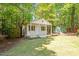 A versatile outbuilding with a porch and functional shed in a shady backyard at 4012 Graham Newton Rd, Raleigh, NC 27606