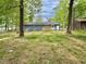 View of the home's expansive backyard, featuring a gray exterior and a wooden deck at 42 S 2Nd St, Roxboro, NC 27573