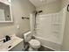 Bathroom featuring a shower over tub, modern fixtures, and storage space at 42 S 2Nd St, Roxboro, NC 27573