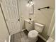 This bathroom features a modern vanity and toilet, complemented by sleek gray flooring at 42 S 2Nd St, Roxboro, NC 27573
