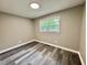 Bright bedroom featuring gray toned floors, neutral walls, and a window that fills the room with light at 42 S 2Nd St, Roxboro, NC 27573