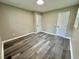 A spacious bedroom is accentuated with gray-toned wood floors and convenient access to two entry doors at 42 S 2Nd St, Roxboro, NC 27573