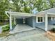 Attached carport with concrete flooring, fresh paint, white trim and exterior door at 42 S 2Nd St, Roxboro, NC 27573