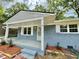 Charming single-story home with blue painted brick, covered porch, white trim, and refreshed landscaping at 42 S 2Nd St, Roxboro, NC 27573