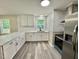 Bright kitchen featuring stone countertops and stainless steel appliances at 42 S 2Nd St, Roxboro, NC 27573
