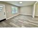 Bright living room featuring gray toned floors, neutral walls, and a large window that fills the room with light at 42 S 2Nd St, Roxboro, NC 27573