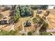 Aerial view of property featuring a two-story home, expansive lawn, and surrounded by trees at 4208 Louisbury Rd, Wake Forest, NC 27587