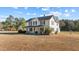 Attractive two-story home with a covered porch, set on a spacious lot under a blue sky at 4208 Louisbury Rd, Wake Forest, NC 27587