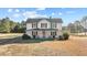 Charming white two-story farmhouse with a covered front porch and classic black shutters at 4208 Louisbury Rd, Wake Forest, NC 27587