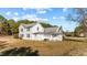Rear exterior showcasing a two-story home with a combination of siding and screened porch at 4208 Louisbury Rd, Wake Forest, NC 27587