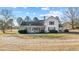 View of home's rear exterior featuring a screened porch, and expansive yard at 4208 Louisbury Rd, Wake Forest, NC 27587