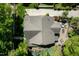 Aerial view of home with landscaped yard, patio seating area, and expansive driveway at 4210 Falls River Ave, Raleigh, NC 27614