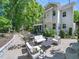 Expansive backyard with stone patio, outdoor seating and lush landscaping at 4210 Falls River Ave, Raleigh, NC 27614