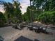 Backyard patio featuring an outdoor fireplace, seating, and string lights for evening ambiance at 4210 Falls River Ave, Raleigh, NC 27614