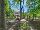 Secluded backyard with lush landscaping, screened-in porch and patio area, ideal for relaxation at 4210 Falls River Ave, Raleigh, NC 27614