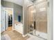 Bathroom featuring a soaking tub and separate glass-enclosed shower at 4210 Falls River Ave, Raleigh, NC 27614