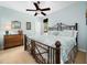 Serene bedroom with light blue walls, a decorative bedframe, and a ceiling fan at 4210 Falls River Ave, Raleigh, NC 27614