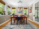 Charming dining room with multiple windows, hardwood floors, and a cozy atmosphere at 4210 Falls River Ave, Raleigh, NC 27614