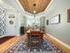 Dining room with a decorative wood ceiling and hardwood floors, offering ample space at 4210 Falls River Ave, Raleigh, NC 27614