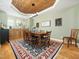Dining room with wood ceiling, hardwood floors, and large windows providing natural light at 4210 Falls River Ave, Raleigh, NC 27614