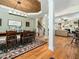 Open-concept dining area featuring a wood ceiling, hardwood floors, and access to the living room at 4210 Falls River Ave, Raleigh, NC 27614