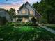 Inviting home with stone accents, lush lawn, and professional landscaping providing great curb appeal at 4210 Falls River Ave, Raleigh, NC 27614